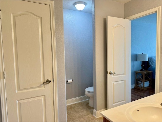 2201 Ezra Ct, Cedar Park, TX 78613 - bathroom with toilet, baseboards, and vanity