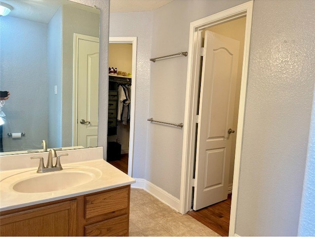 2201 Ezra Ct, Cedar Park, TX 78613 - bathroom featuring vanity, baseboards, and a spacious closet