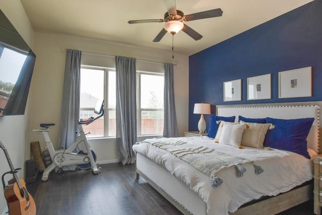 bedroom featuring baseboards, ceiling fan, and dark wood-type flooring