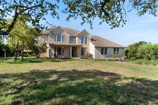 traditional home with stone siding and a front yard