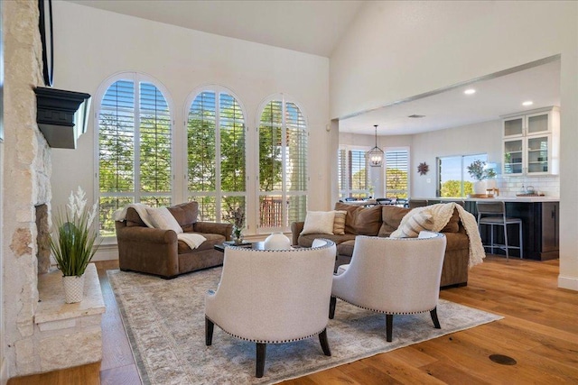 19215 White Horse Cv, Spicewood, TX 78669 - living area with light wood-style flooring, recessed lighting, and high vaulted ceiling