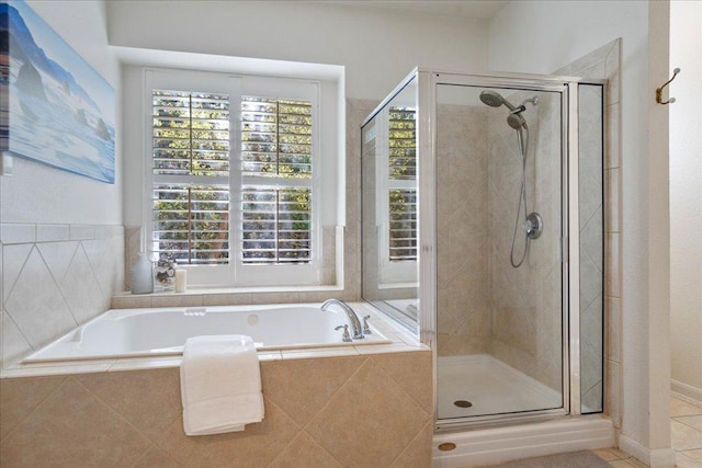 19215 White Horse Cv, Spicewood, TX 78669 - full bathroom with a bath, a shower stall, and tile patterned floors