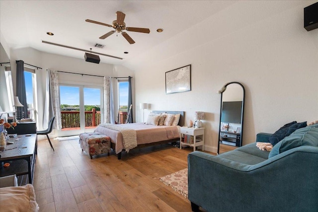 bedroom with access to outside, lofted ceiling, hardwood / wood-style flooring, and recessed lighting