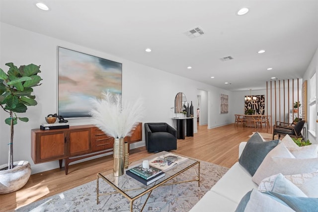 2004 Raleigh Ave, Austin, TX 78703 - living room featuring light wood-type flooring, recessed lighting, and a chandelier