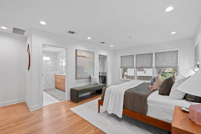 2004 Raleigh Ave, Austin, TX 78703 - bedroom featuring light wood-type flooring, recessed lighting, a spacious closet, and ensuite bath