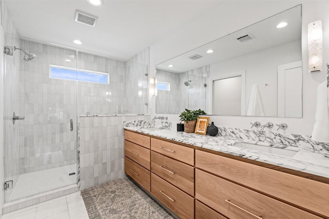 2004 Raleigh Ave, Austin, TX 78703 - full bathroom featuring double vanity, a shower stall, recessed lighting, and tile patterned floors