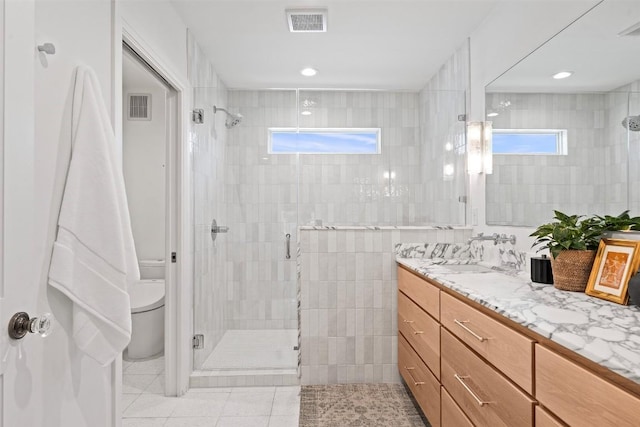 2004 Raleigh Ave, Austin, TX 78703 - full bathroom with a stall shower, vanity, tile patterned flooring, and recessed lighting