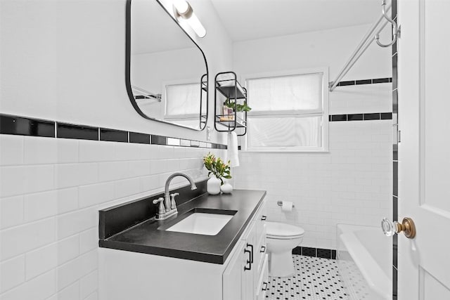 2004 Raleigh Ave, Austin, TX 78703 - bathroom with tile walls, vanity, washtub / shower combination, tile patterned flooring, and wainscoting