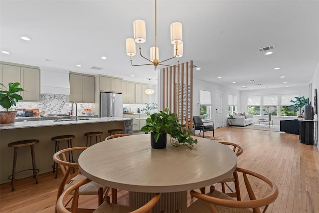 2004 Raleigh Ave, Austin, TX 78703 - dining area with light wood-style floors, a chandelier, and recessed lighting
