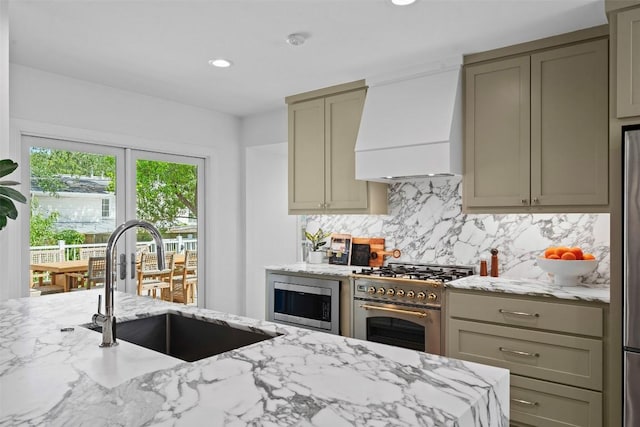 2004 Raleigh Ave, Austin, TX 78703 - kitchen featuring custom range hood, stainless steel appliances, decorative backsplash, light stone counters, and recessed lighting