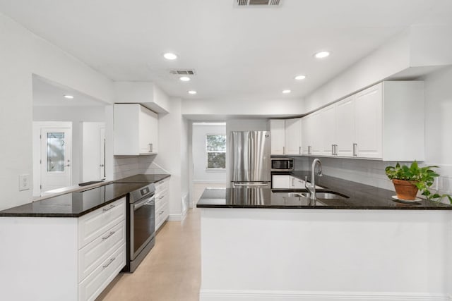 13212 Running Doe Ln, Cedar Park, TX 78613 - kitchen featuring a sink, stainless steel appliances, a peninsula, tasteful backsplash, and recessed lighting