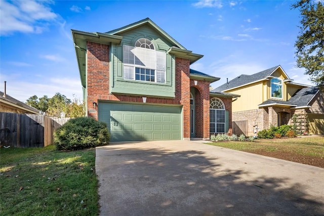 traditional-style home featuring brick siding, driveway, fence, and an attached garage