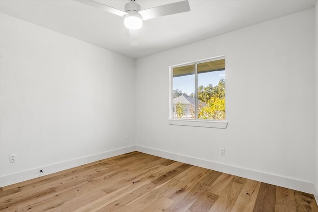 spare room with light wood-style floors, ceiling fan, and baseboards