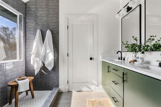 full bath featuring tile patterned floors, double vanity, and a sink