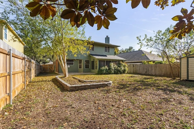 view of yard featuring a fenced backyard and an outdoor structure