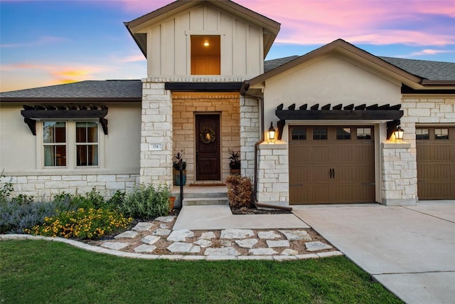 174 Challis Ct, Austin, TX 78737 - view of front of property with stone siding, an attached garage, concrete driveway, and board and batten siding