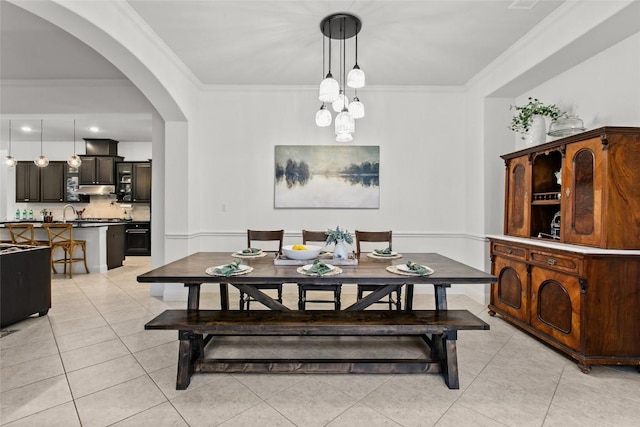 174 Challis Ct, Austin, TX 78737 - dining area featuring arched walkways, light tile patterned floors, and crown molding