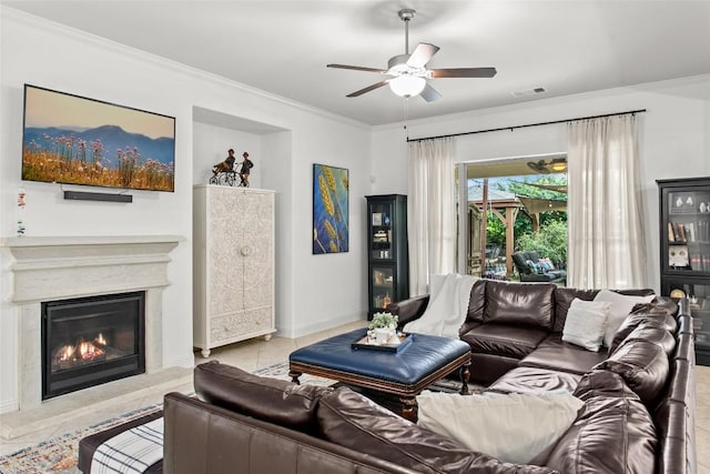 174 Challis Ct, Austin, TX 78737 - tiled living area with a ceiling fan, crown molding, a glass covered fireplace, and baseboards