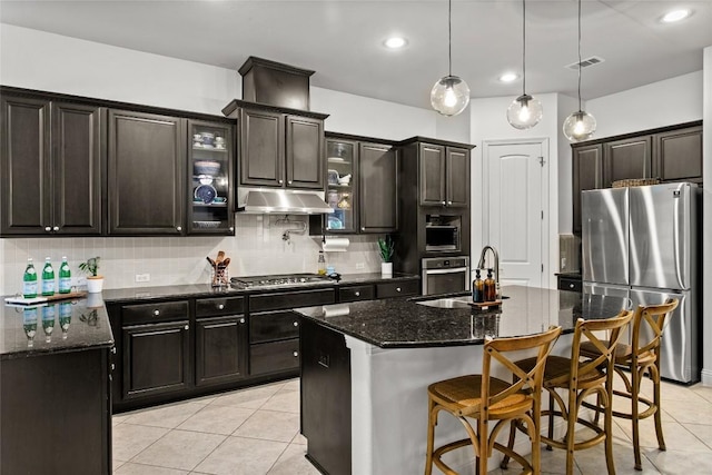 174 Challis Ct, Austin, TX 78737 - kitchen with appliances with stainless steel finishes, a sink, light tile patterned floors, decorative backsplash, and dark stone countertops