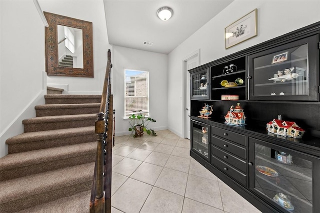 174 Challis Ct, Austin, TX 78737 - entrance foyer featuring stairs, beverage cooler, light tile patterned floors, and baseboards