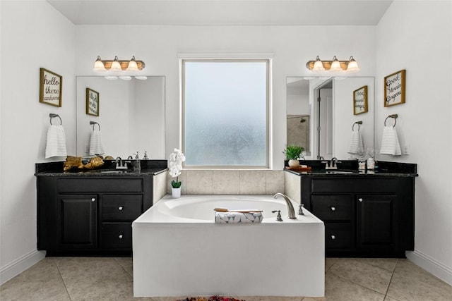 174 Challis Ct, Austin, TX 78737 - bathroom with tile patterned flooring, two vanities, a bath, and baseboards