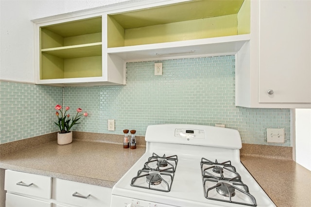 kitchen featuring white range with gas cooktop, open shelves, backsplash, and white cabinetry