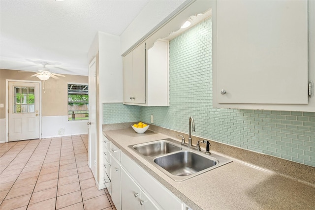 kitchen featuring white cabinetry, light tile patterned floors, ceiling fan, and a sink