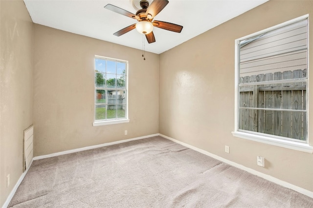 unfurnished room with ceiling fan, baseboards, and carpet flooring