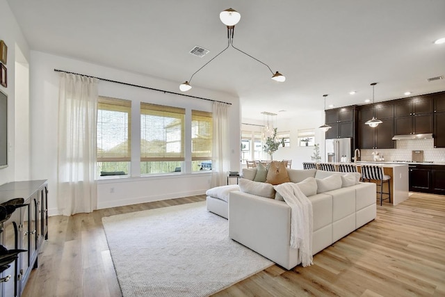 653 Texas Sage Loop, Buda, TX 78610 - living area with light wood finished floors, recessed lighting, and baseboards