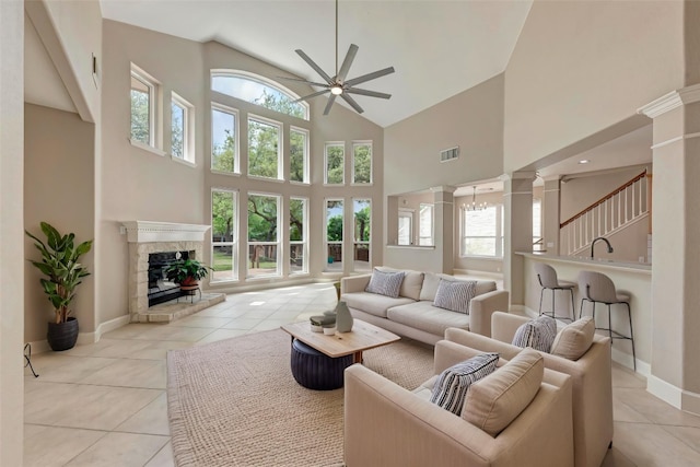 8105 Endeavor Cir, Austin, TX 78726 - living room with a ceiling fan, high vaulted ceiling, light tile patterned floors, decorative columns, and healthy amount of natural light