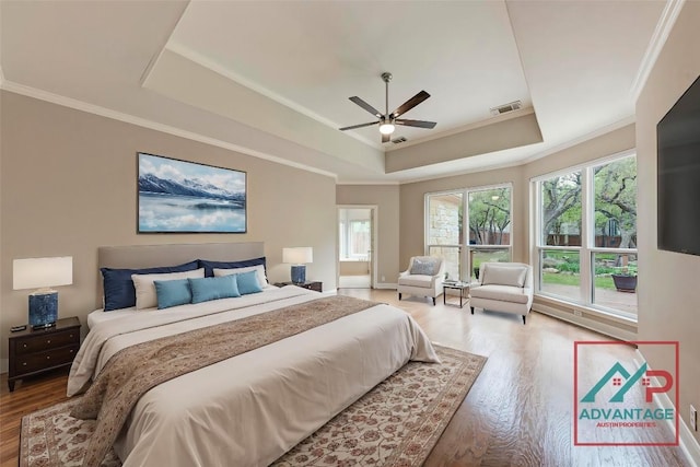 8105 Endeavor Cir, Austin, TX 78726 - bedroom with a raised ceiling, wood finished floors, ornamental molding, multiple windows, and a ceiling fan