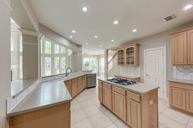 8105 Endeavor Cir, Austin, TX 78726 - kitchen with stainless steel appliances, recessed lighting, a center island, backsplash, and glass insert cabinets