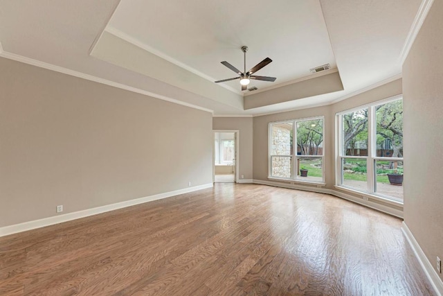 8105 Endeavor Cir, Austin, TX 78726 - spare room with a raised ceiling, ceiling fan, wood finished floors, and crown molding