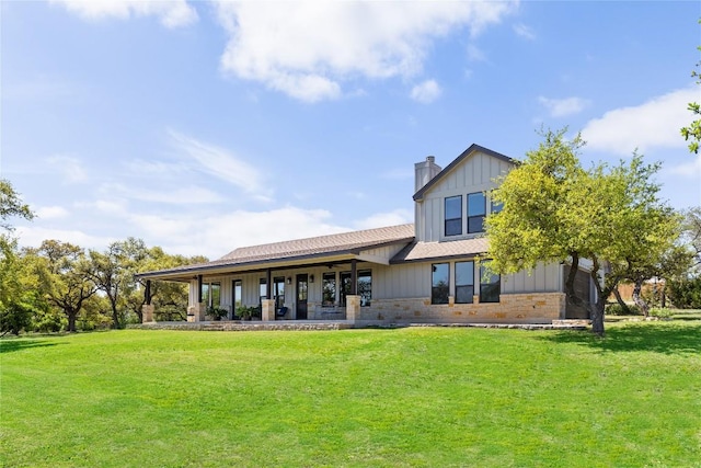 18105 Austin Blvd, Lago Vista, TX 78645 - back of house with a yard, a chimney, and board and batten siding