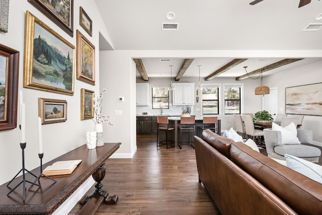 18105 Austin Blvd, Lago Vista, TX 78645 - living area featuring dark wood finished floors, beamed ceiling, and a ceiling fan
