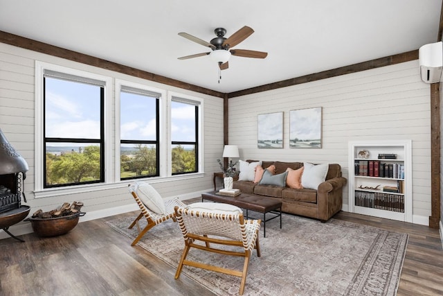 18105 Austin Blvd, Lago Vista, TX 78645 - living area with wooden walls, ceiling fan, wood finished floors, and a wall mounted air conditioner