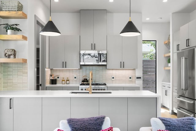 kitchen featuring light countertops, stainless steel appliances, and open shelves