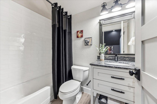 3204 Whitt Creek Trl, Leander, TX 78641 - bathroom featuring toilet, vanity, shower / bath combo, wood finished floors, and a textured wall