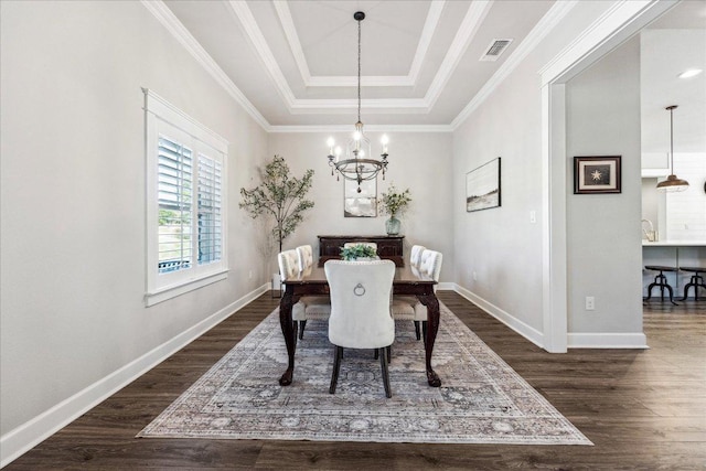 3204 Whitt Creek Trl, Leander, TX 78641 - dining room with a chandelier, dark wood-type flooring, a raised ceiling, baseboards, and crown molding