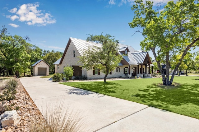 3204 Whitt Creek Trl, Leander, TX 78641 - view of front of property featuring an outbuilding, a front lawn, a garage, metal roof, and concrete driveway