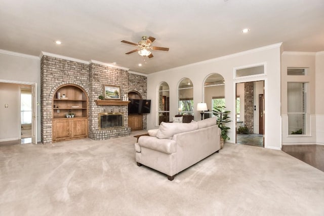 200 Nicole Way, Georgetown, TX 78633 - living area featuring ceiling fan, built in features, a brick fireplace, crown molding, and baseboards