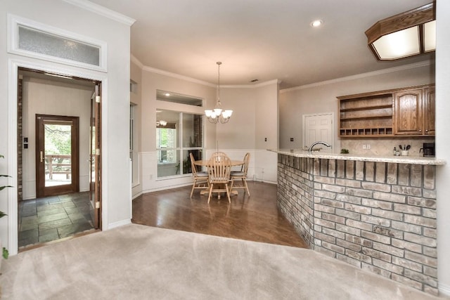200 Nicole Way, Georgetown, TX 78633 - kitchen featuring open shelves, brown cabinetry, a chandelier, crown molding, and healthy amount of natural light