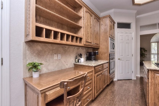 200 Nicole Way, Georgetown, TX 78633 - kitchen featuring open shelves, ornamental molding, appliances with stainless steel finishes, dark wood-style floors, and brown cabinetry