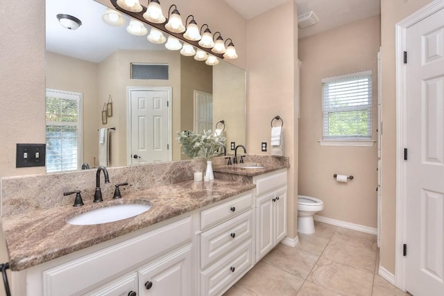 200 Nicole Way, Georgetown, TX 78633 - full bathroom featuring double vanity, toilet, healthy amount of natural light, and baseboards