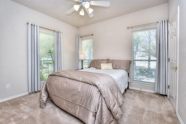 200 Nicole Way, Georgetown, TX 78633 - bedroom with light carpet, multiple windows, baseboards, and a ceiling fan