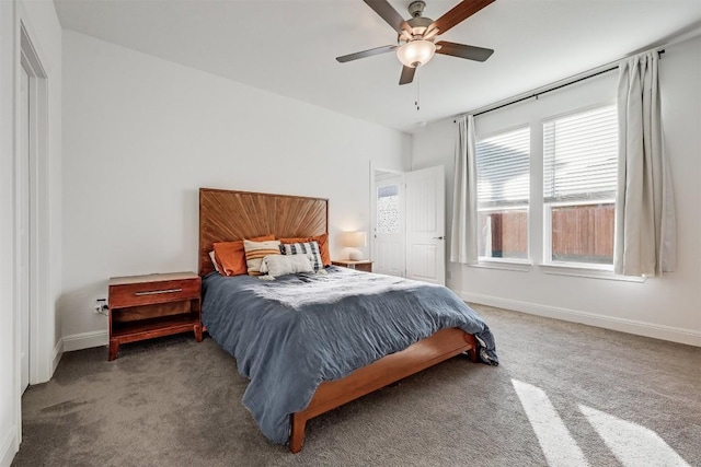 carpeted bedroom with ceiling fan and baseboards