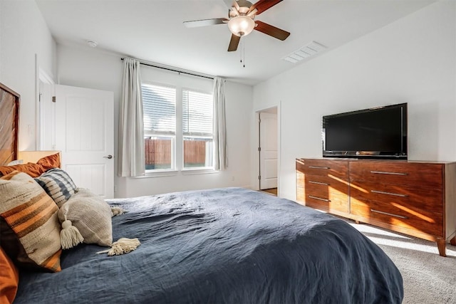 carpeted bedroom featuring visible vents and ceiling fan