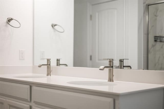 bathroom featuring an enclosed shower and vanity