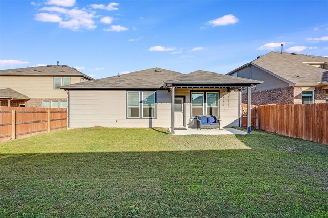 rear view of house with a yard, a fenced backyard, and a patio