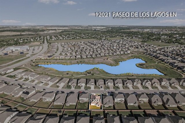 birds eye view of property with a residential view and a water view